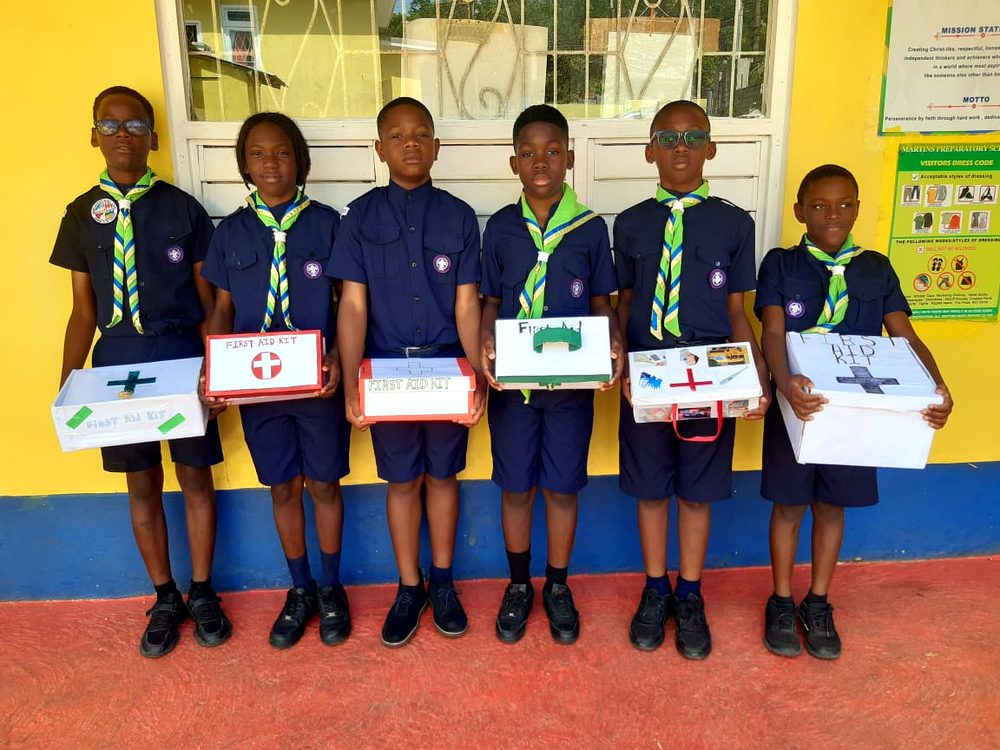 Cub scouts holding first-aid kit projects they built
