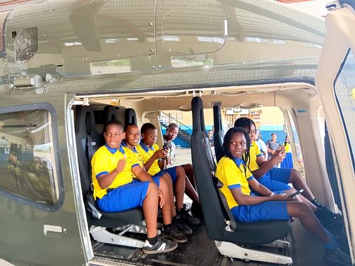 Pupils exploring a Jamaica Defence Force helicopter