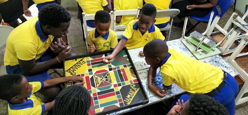 Pupils playing a Caribbean board game
